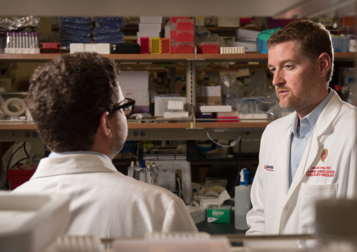 Dr. Josh Lang talks with Dr. David Kosoff in the lab