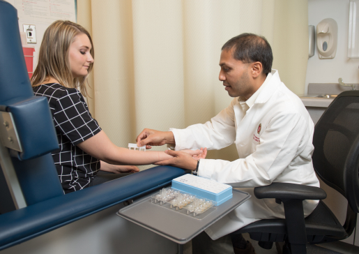 Dr. Ravi Viswanathan administers a skin test in the clinic