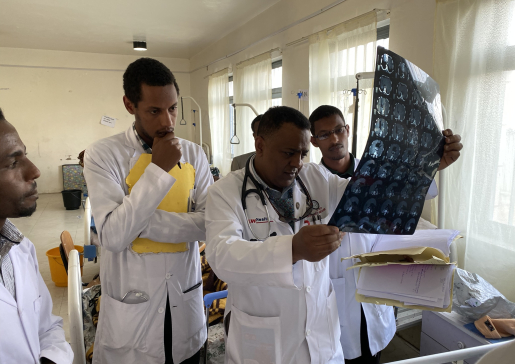 Dr. Siraj looks at an x-ray with colleagues during a global health trip to Ethiopia