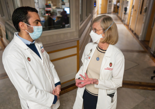 Heart failure cardiologist Dr. Maryl Johnson and fellow Dr. Ahmed Elkhouly talk in a hallway at University Hospital