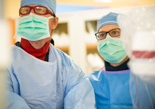 Dr. Kurt Jacobson and interventional cardiology fellow working together in the cath lab at University Hospital