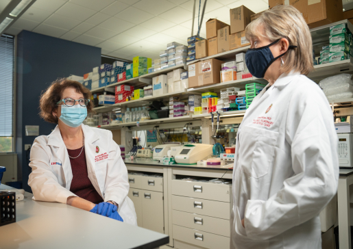 Dr. Lynn Schnapp and Dr. Carole Wilson talk in the lab