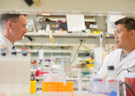 Dr. Alexey Glukhov talks to a member of the research team in the lab