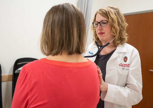 Dr. Erin Lowery uses a stethoscope to examine a patient in the clinic