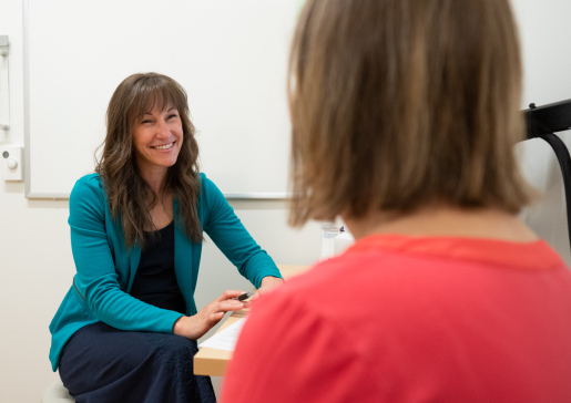 A cystic fibrosis clinical research coordinator talks to a prospective study participant in the clinic