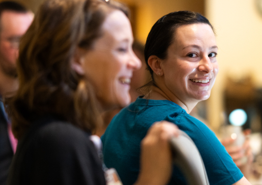 Photo of Dr. Sara Johnson looking back at the camera with colleagues at her side