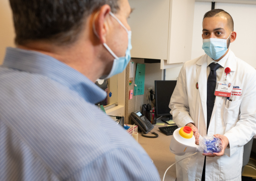 Allergy and Immunology fellow talking with faculty member in clinic