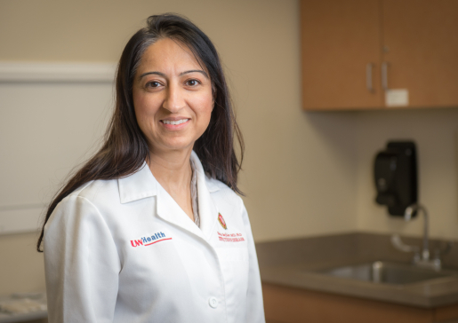 Dr. Nasia Safdar wearing a white lab coat in the clinic