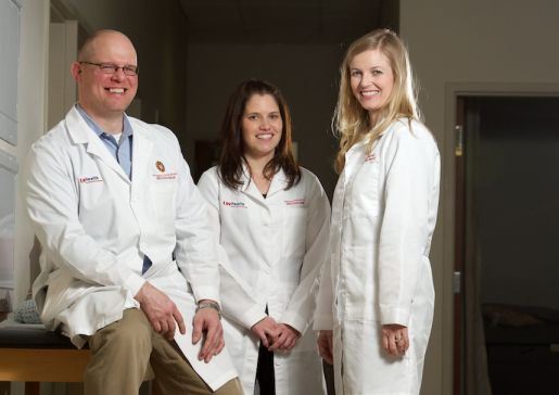 Three infectious disease physicians with white coats