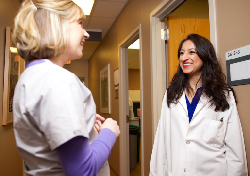 Dr. Nasia Safdar and colleague talking in the hall of UW Hospital