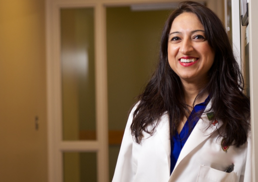 Environmental photo of Dr. Nasia Safdar leaning against a clinic wall