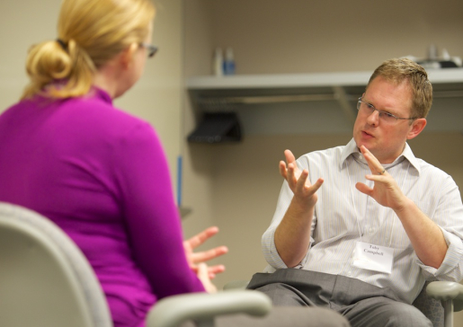 Dr. Toby Campbell talks with a participant in a communication workshop
