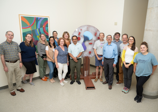 Group photo of Jarjour research team in WIMR passageway with Eosinophil sculpture