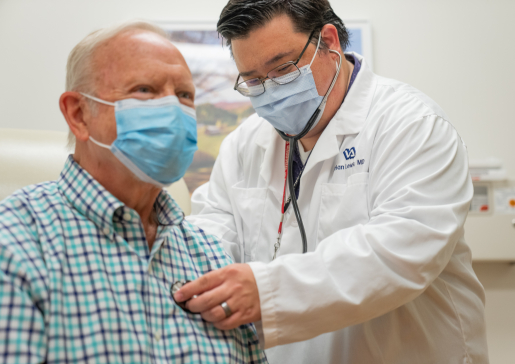 Dr. Adrian Lewis caring for a patient at the VA