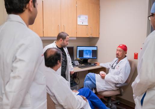 The interventional nephrology team talks at a desk at University Hospital