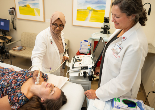 Endocrinology fellow Dr. Shakera Syed performs an ultrasound on a patient while Dr. Jennifer Poehls oversees