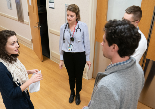 Infectious Disease faculty and learners talking in a hallway at University Hospital