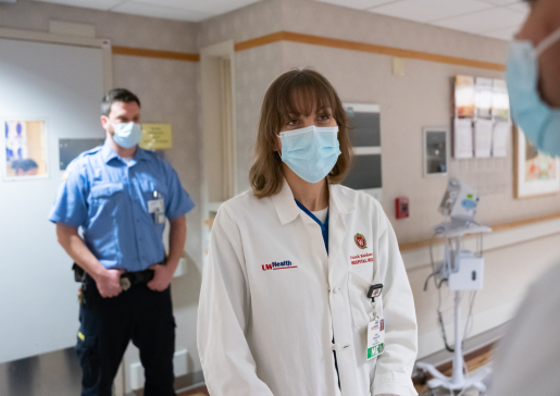 Dr. Farah Kaiksow and learner with corrections officer in background