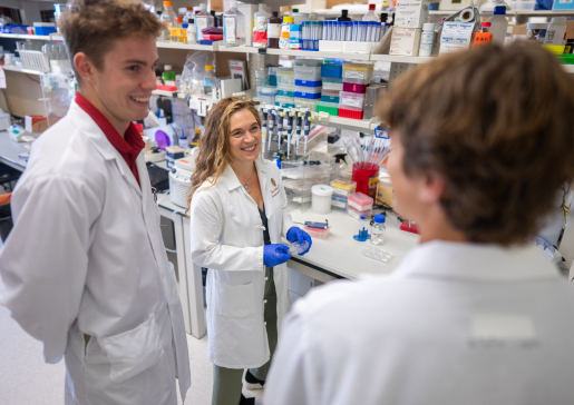 Dr. Lee Eckhart (center) talks with undergraduate research assistants Maxwell Milaitis and Walter Stanwood