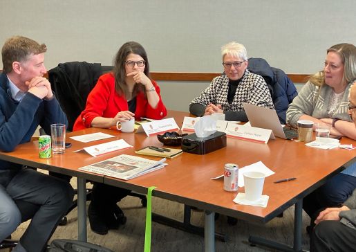 Department faculty and staff work around a table at a leadership retreat