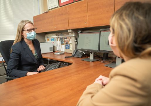 Dr. Bartels at her desk with a medical student