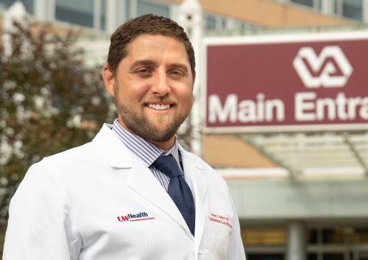 Outdoor photo of Dr. Adam Gepner outside of the William S. Middleton Veterans Hospital