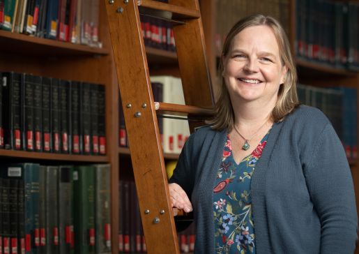 Dr. Heidi Twedt stands in front of a ladder at the School of Medicine and Public Health's Ebling Library