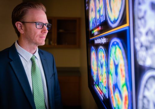 Sterling Johnson, PhD, professor, Geriatrics and Gerontology, views brain imaging results.