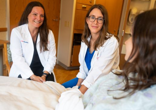 Doctors Anna Heimbecher, and Maggie Steingraber-Pharr consult at bedside
