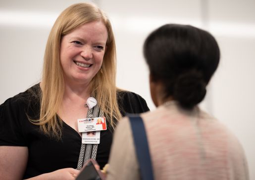 Dr. Siobhan Byrne talks to a colleague at a Department of Medicine event