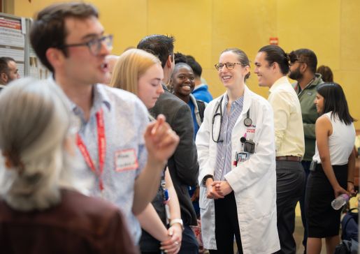 People stand talking at a poster session