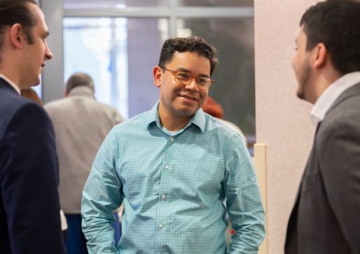 Dr. Caldera talking to two men in suits.