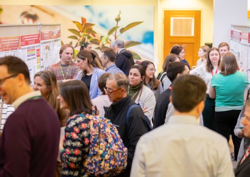 Participants mingle at the 2026 DOM Education Day poster presentation.