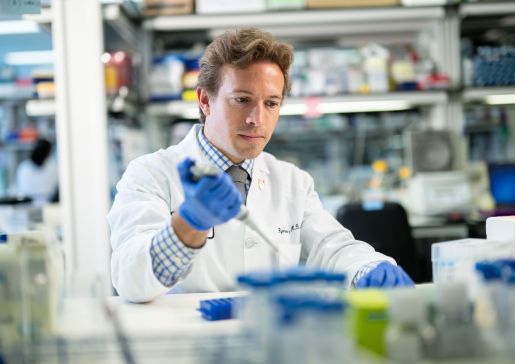 Ryan Denu in the lab with a pipette