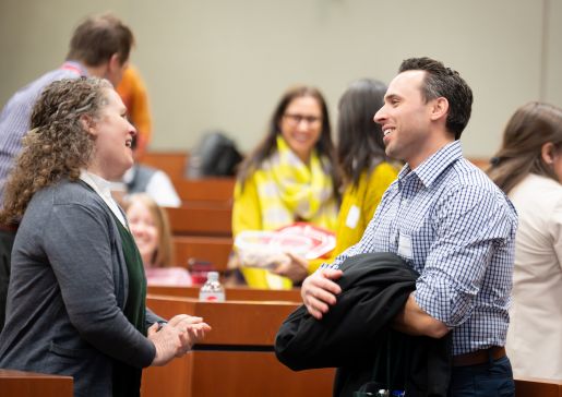 Several people talking in an auditorium